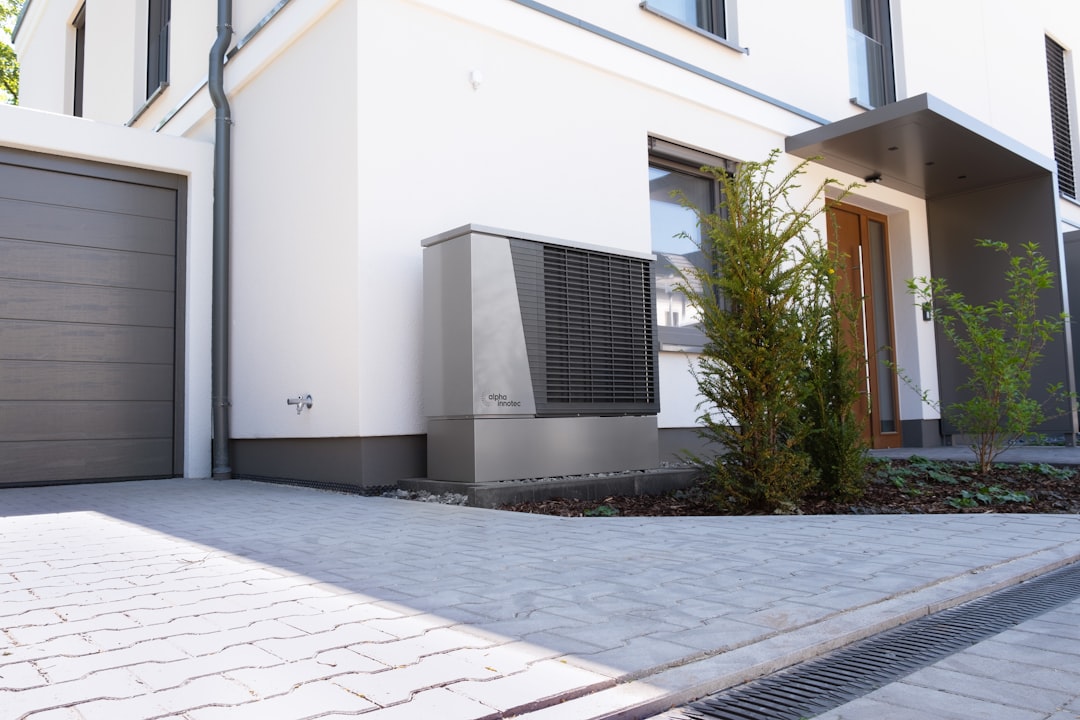 HVAC Blog 1 heat pump unit installed outside a home during a snowy Northeast winter - heat pump benefits for northeast homeowners